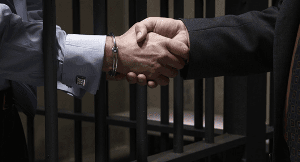 jail cell shaking hands